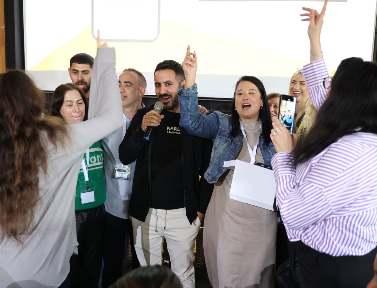 A facilitator leading a large audience